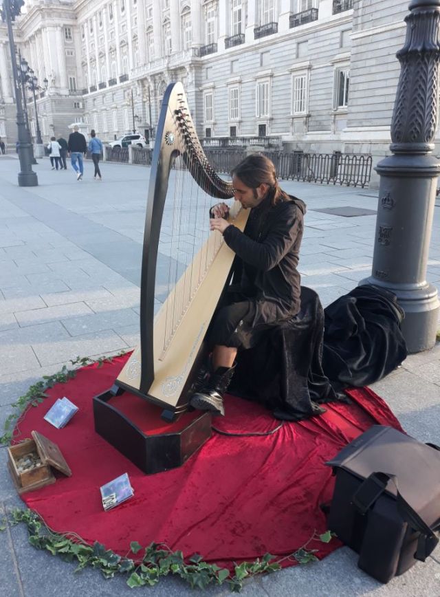 Spanish musician plays the harp outside Madrid's Royal Palace